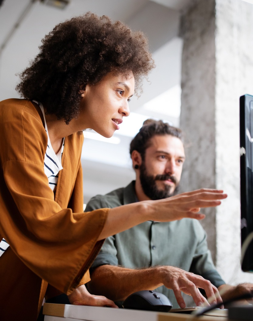 A man and a woman looking at a screen