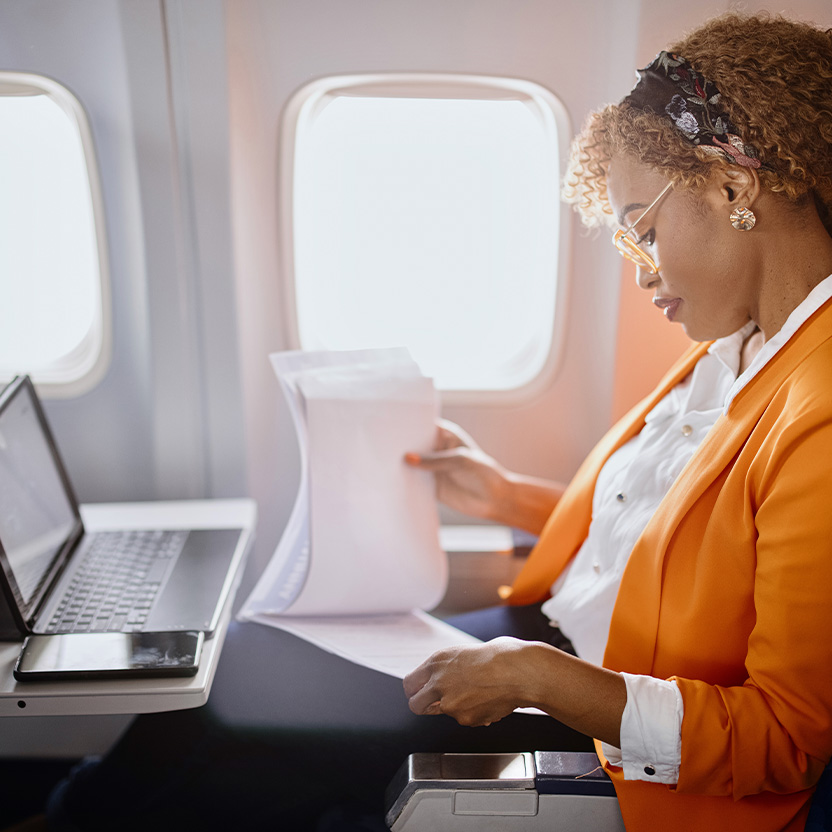 A woman on a plane with her laptop