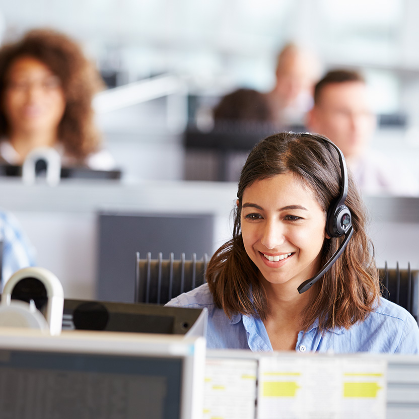 A support center employee with headphones on