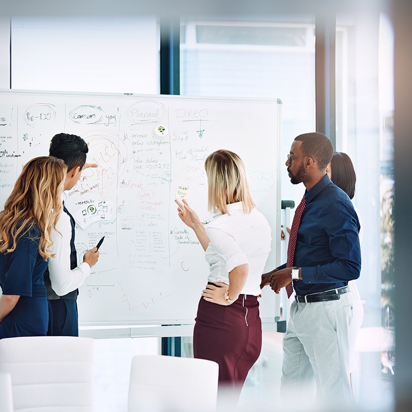 Employees looking at a whiteboard